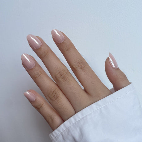 Short almond press-on nails in nude gel finish on Indian skin tone – HeyBabes