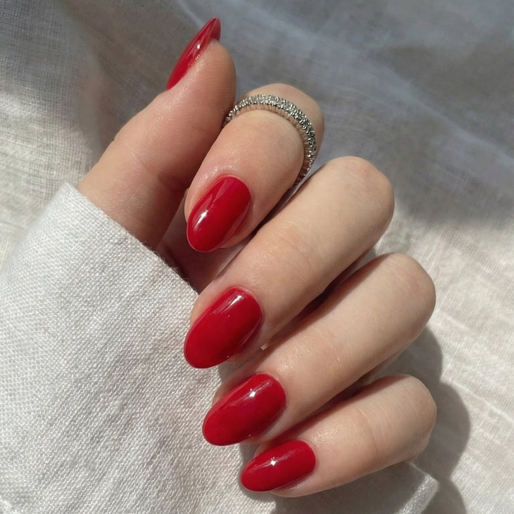 Luxury Classic Red Press-On Nails | Glossy Short Oval | 32 nail sizes press-on nails worn on hand close-up